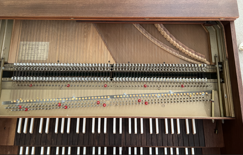 Harpsichord interior showing levers for turning various registers on and off.